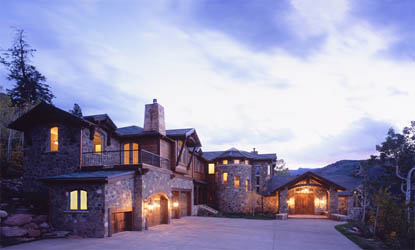 Luxurious stone mansion at twilight with circular driveway